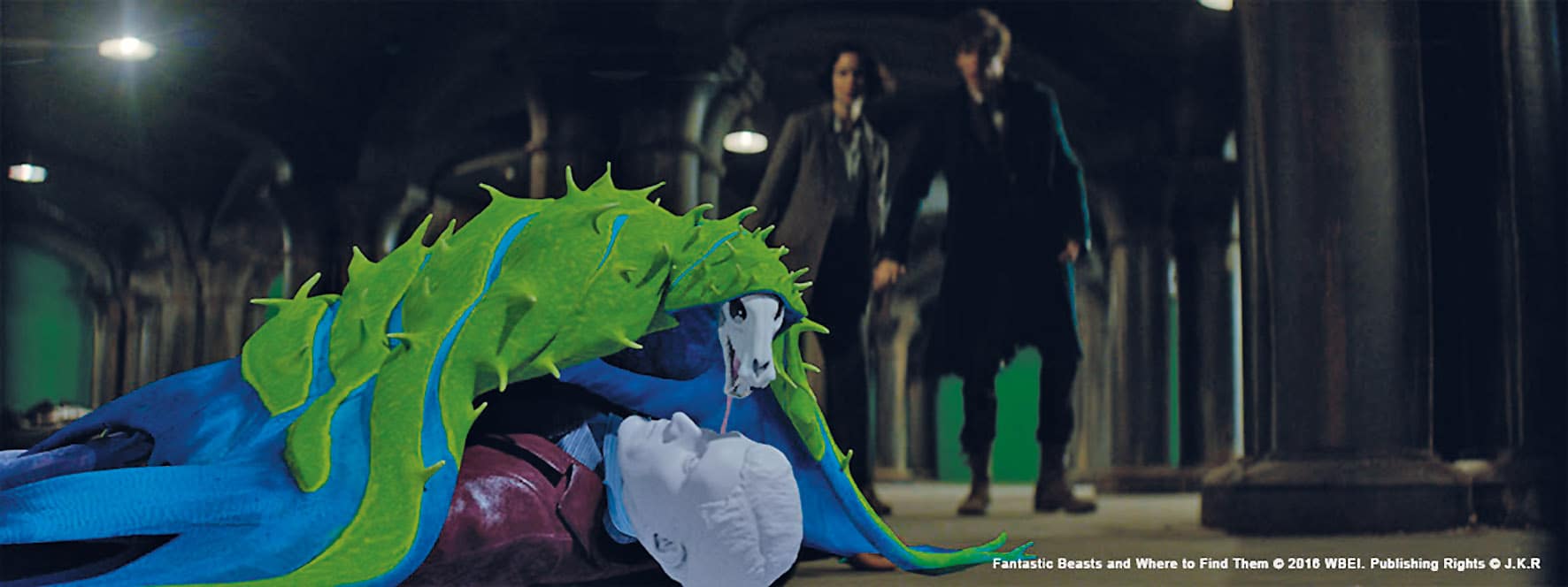 a colorful creature with tentaclelike features lies on the ground in a dimly lit space two figures are seen in the background approaching the creature the setting has an industrial feel with arches and columns digital production A colorful creature with tentacle-like features lies on the ground in a dimly lit space. Two figures are seen in the background, approaching the creature. The setting has an industrial feel with arches and columns.