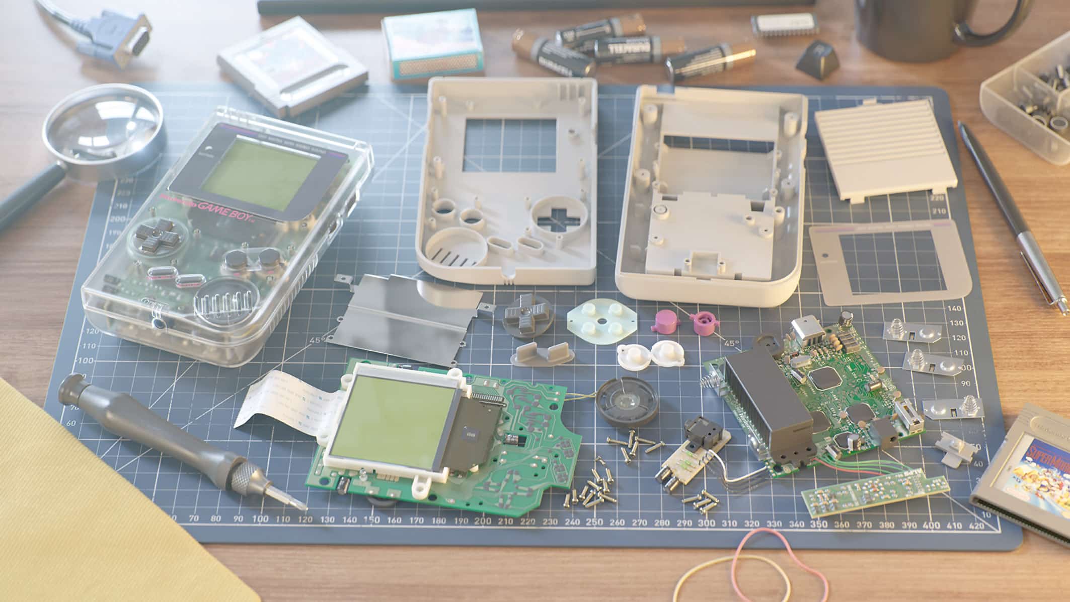 disassembled game boy consoles and their components on a work surface including circuit boards buttons and tools like a magnifying glass and a soldering iron digital production Disassembled Game Boy consoles and their components on a work surface, including circuit boards, buttons, and tools like a magnifying glass and a soldering iron.