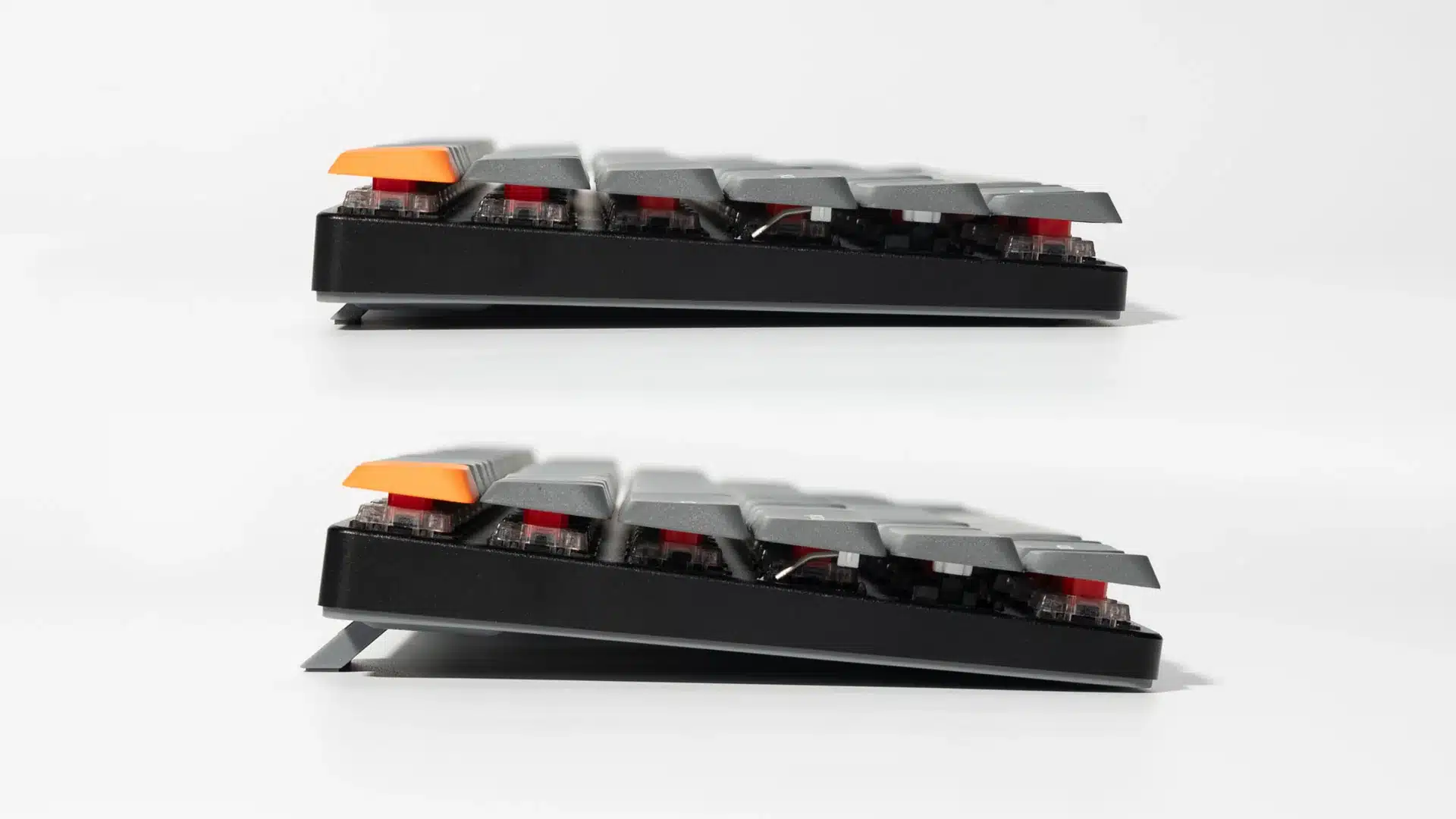 a side view of a mechanical keyboard showing two different height adjustments with some keys highlighted in orange and red the keyboard has a black frame with a sleek design digital production A side view of a mechanical keyboard showing two different height adjustments with some keys highlighted in orange and red. The keyboard has a black frame with a sleek design.