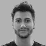 a closeup portrait of a person with short dark hair and facial hair wearing a black shirt against a gray background the individual has a neutral expression and an earring in one ear digital production A close-up portrait of a person with short, dark hair and facial hair, wearing a black shirt against a gray background. The individual has a neutral expression and an earring in one ear.