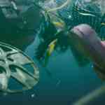 underwater view showing various debris including a plastic film reel and a pink rubber boot along with fishing nets and other discarded items bubbles and sediment are visible in the water digital production Underwater view showing various debris, including a plastic film reel and a pink rubber boot, along with fishing nets and other discarded items. Bubbles and sediment are visible in the water.
