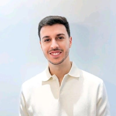 a man smiling in a lightcolored polo shirt digital production A man smiling in a light-colored polo shirt.