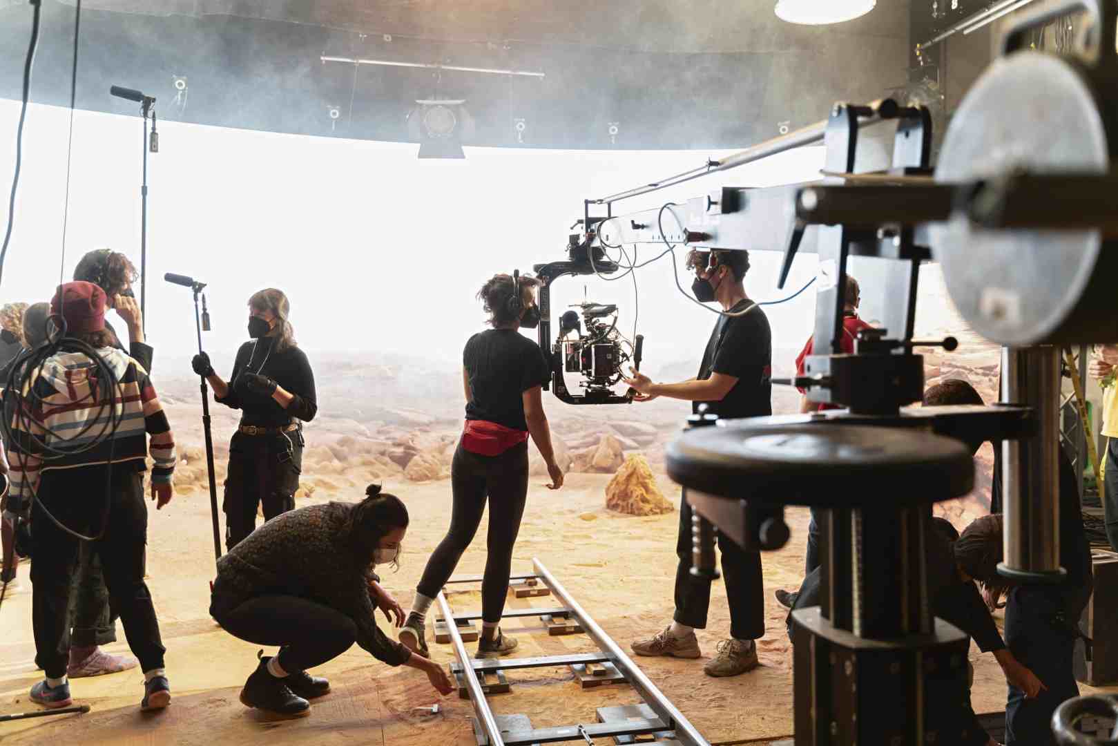 film crew setting up on a movie set digital production Film crew setting up on a movie set