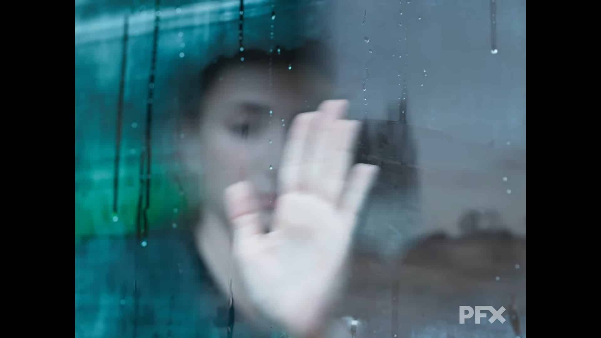 a person pressing their hand against a rainsoaked window digital production A person pressing their hand against a rain-soaked window.