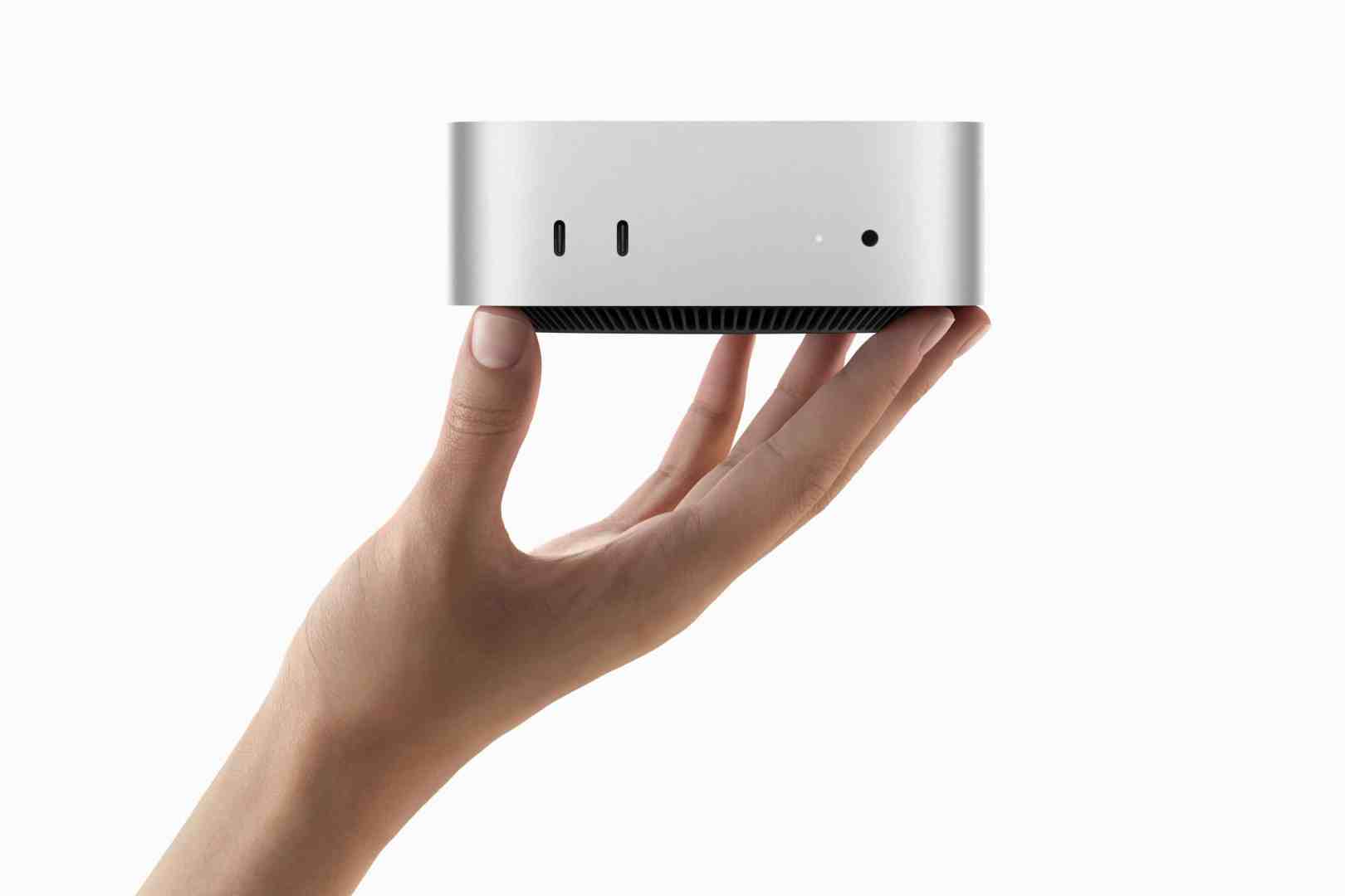 a hand holding a small sleek silver device with ports on one side digital production A hand holding a small, sleek, silver device with ports on one side.