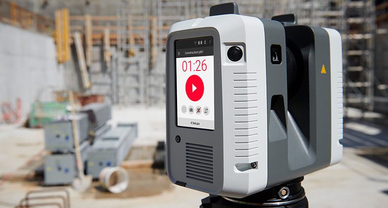 a surveying instrument set on a tripod at a construction site digital production A leica lidar instrument set on a tripod at a construction site.