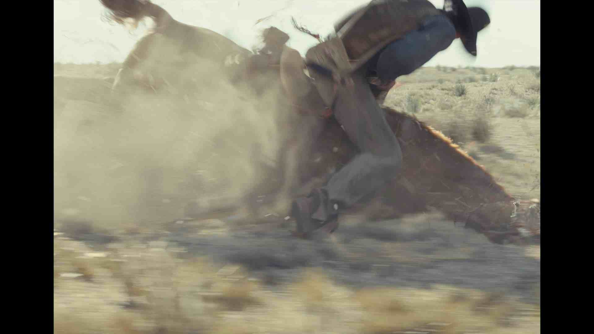 a cowboy riding a bucking horse on a dusty landscape with dust swirling around them captured in motion the horse appears to be rearing up showcasing the dynamic interaction between horse and rider digital production A cowboy riding a bucking horse on a dusty landscape, with dust swirling around them, captured in motion. The horse appears to be rearing up, showcasing the dynamic interaction between horse and rider.
