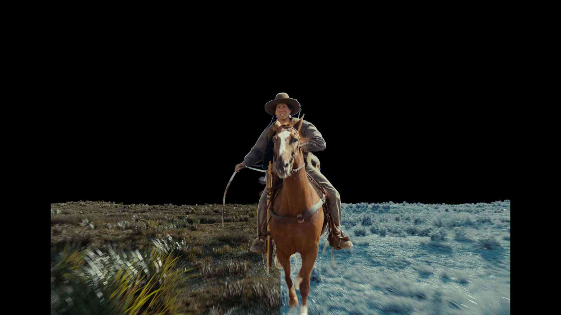 a person riding a brown horse through a landscape with colorful foliage wearing a widebrimmed hat and holding a lasso in one hand the background features a mix of grassy terrain and blue sky digital production A person riding a brown horse through a landscape with colorful foliage, wearing a wide-brimmed hat and holding a lasso in one hand. The background features a mix of grassy terrain and blue sky.
