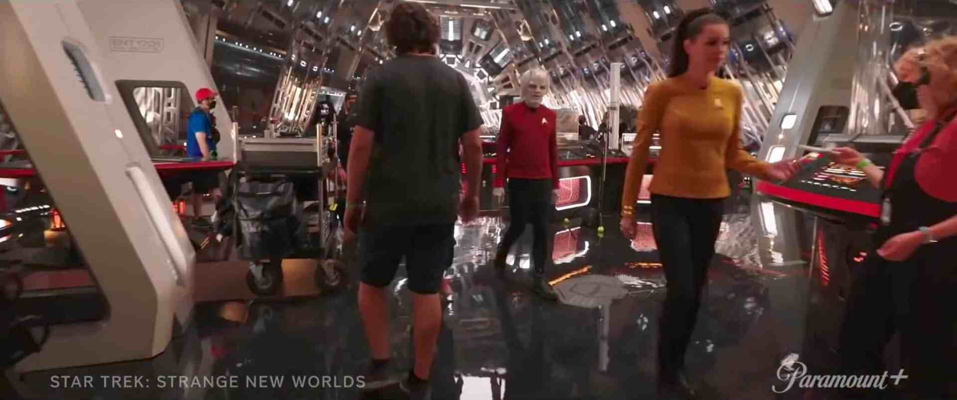 a group of characters moving around a futuristic spaceship interior one person is walking away while another in a mustard yellow top is passing by a robotic character the reflective floor adds to the scifi atmosphere digital production A group of characters moving around a futuristic spaceship interior. One person is walking away, while another in a mustard yellow top is passing by a robotic character. The reflective floor adds to the sci-fi atmosphere.