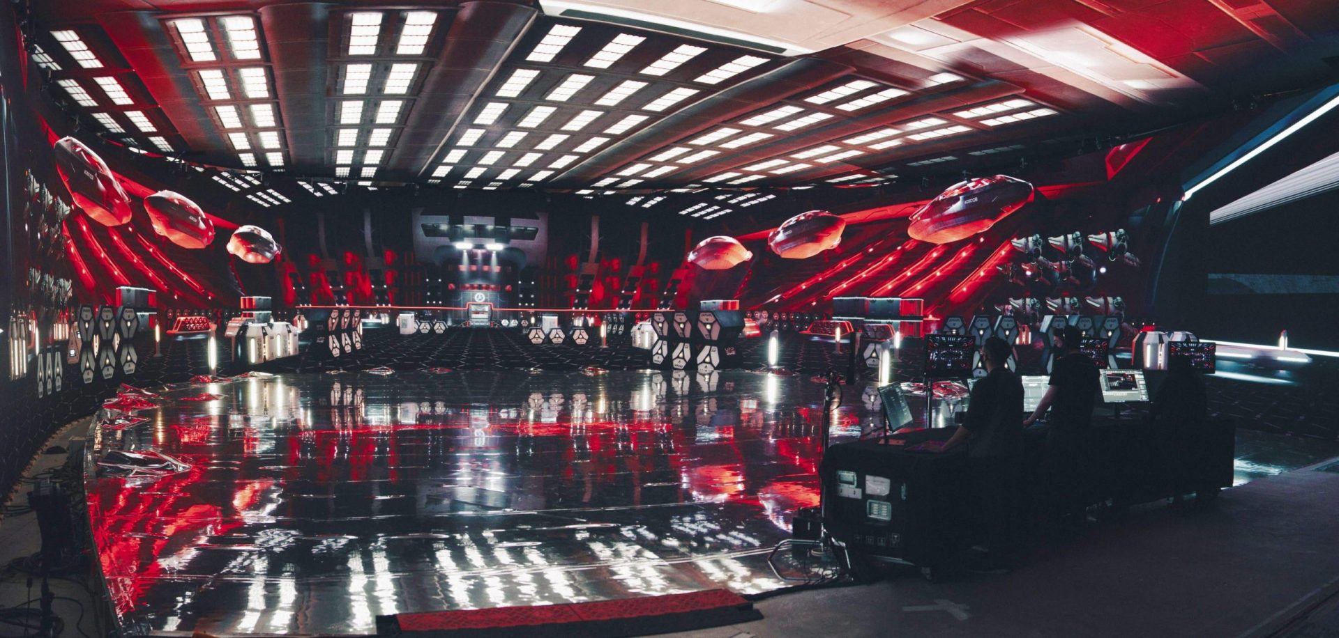 a futuristic room with vibrant red and black colors featuring sleek smooth surfaces reflecting light equipped with advanced technology it has suspended orbs and a control area in the foreground suggesting a scifi setting digital production A futuristic room with vibrant red and black colors, featuring sleek, smooth surfaces reflecting light. Equipped with advanced technology, it has suspended orbs and a control area in the foreground, suggesting a sci-fi setting.