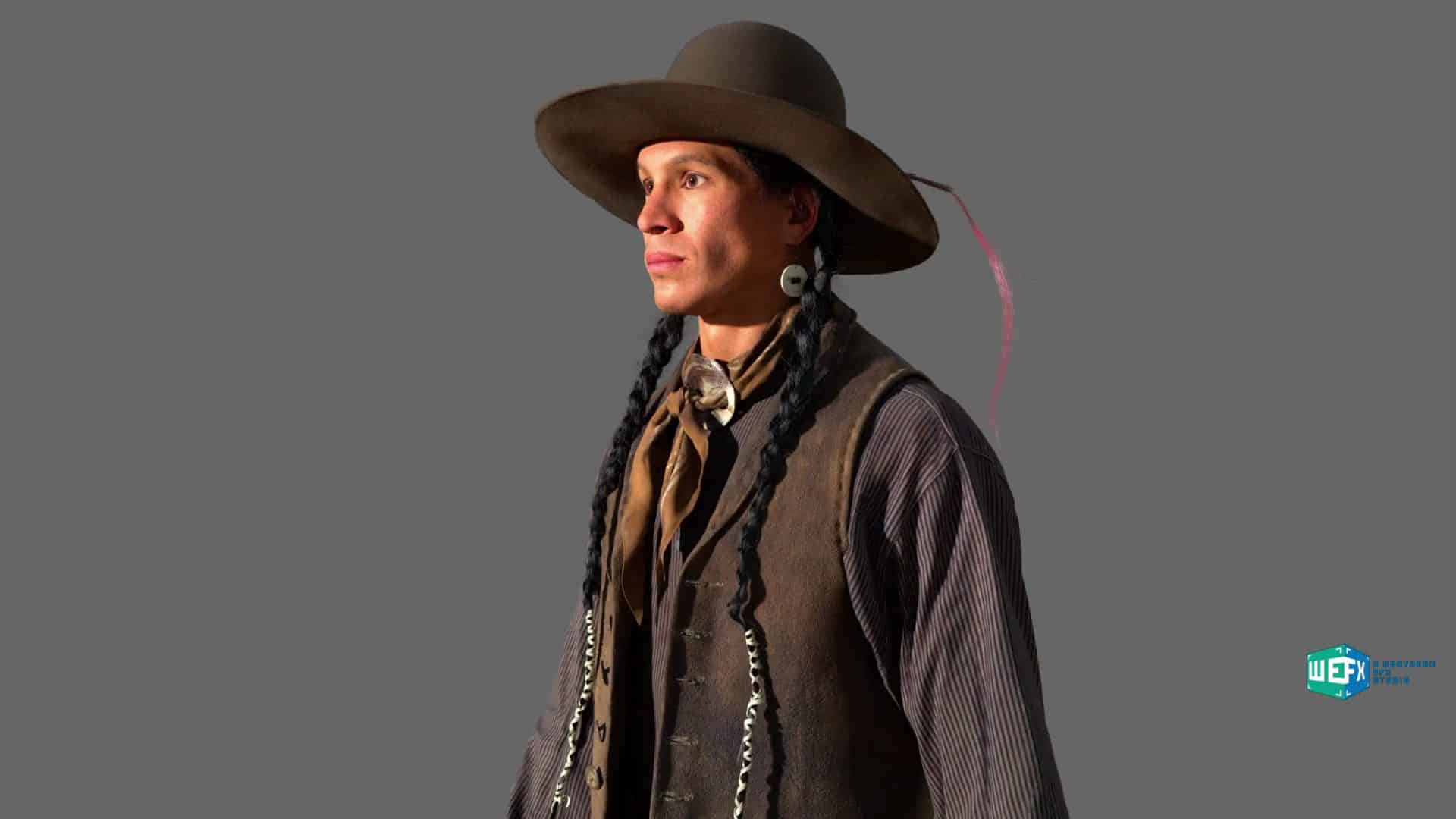 a man with long braids wearing a widebrimmed hat and a vest standing against a gray background he has a calm expression and is dressed in traditional attire reflecting his heritage digital production A man with long braids wearing a wide-brimmed hat and a vest, standing against a gray background. He has a calm expression and is dressed in traditional attire reflecting his heritage.