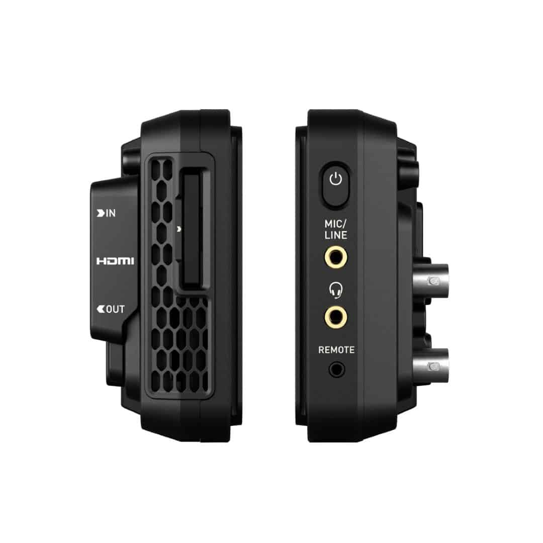 a black audio interface device viewed from the side displaying ports for hdmi inputoutput connections a microphoneline jack and a remote control input with a textured surface for grip digital production A black audio interface device viewed from the side, displaying ports for HDMI, input/output connections, a microphone/line jack, and a remote control input, with a textured surface for grip.