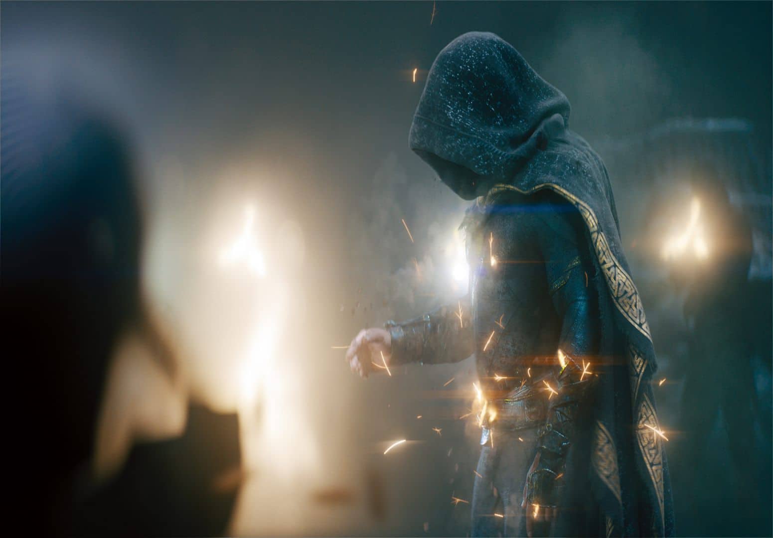 a cloaked figure casting spells with glowing sparks surrounding their hand the background features blurred light enhancing the mystical atmosphere digital production A cloaked figure casting spells, with glowing sparks surrounding their hand. The background features blurred light, enhancing the mystical atmosphere.