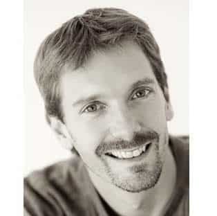 a smiling man with short brown hair and a light beard wearing a dark shirt the background is softly blurred highlighting his cheerful expression and friendly demeanor digital production A smiling man with short brown hair and a light beard, wearing a dark shirt. The background is softly blurred, highlighting his cheerful expression and friendly demeanor.