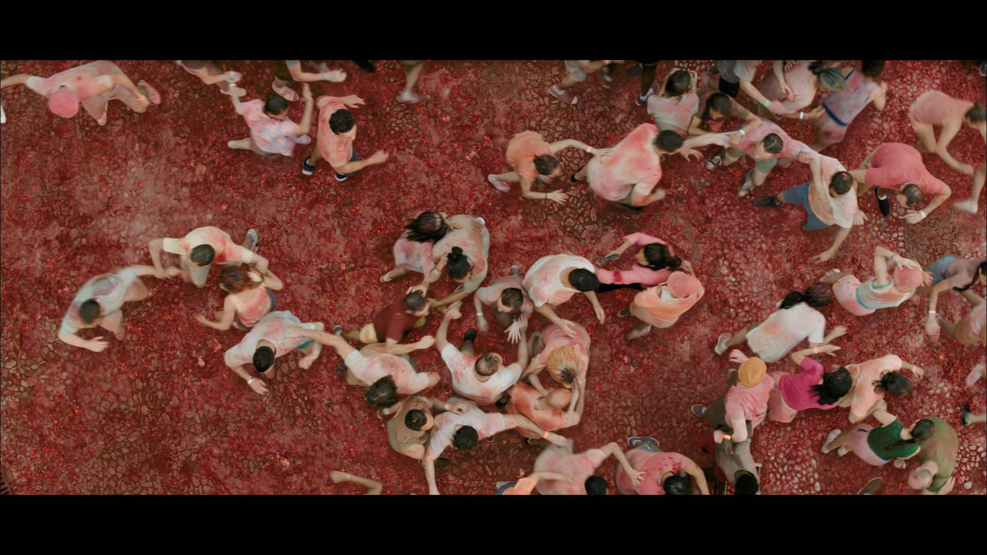 an aerial view of a large group of people participating in a color festival covered in red pigment or powder on a ground with a similar red hue people are scattered some playing and others interacting digital production An aerial view of a large group of people participating in a color festival, covered in red pigment or powder, on a ground with a similar red hue. People are scattered, some playing and others interacting.