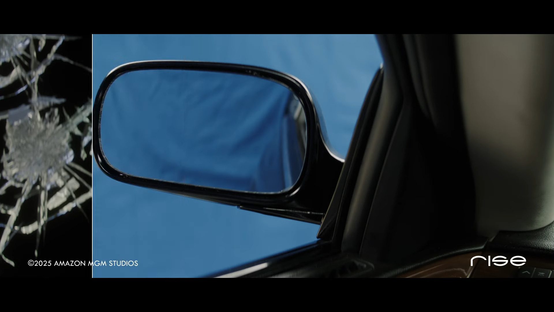 a closeup of a side car mirror reflecting a blue background with a contrasting image of a cracked window the scene suggests a moment of tension or disruption digital production A close-up of a side car mirror reflecting a blue background, with a contrasting image of a cracked window. The scene suggests a moment of tension or disruption.