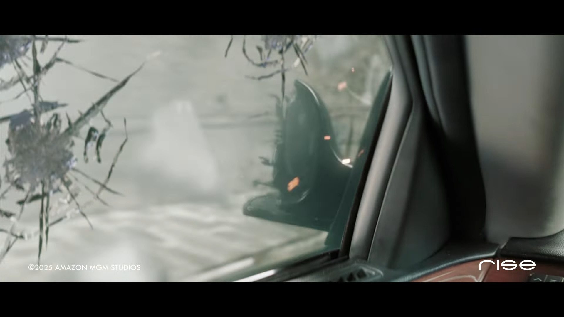 a closeup view from inside a vehicle showing a damaged window with spiderweblike cracks outside a blurred urban scene is visible hinting at chaos or an accident digital production A close-up view from inside a vehicle showing a damaged window with spiderweb-like cracks. Outside, a blurred urban scene is visible, hinting at chaos or an accident.