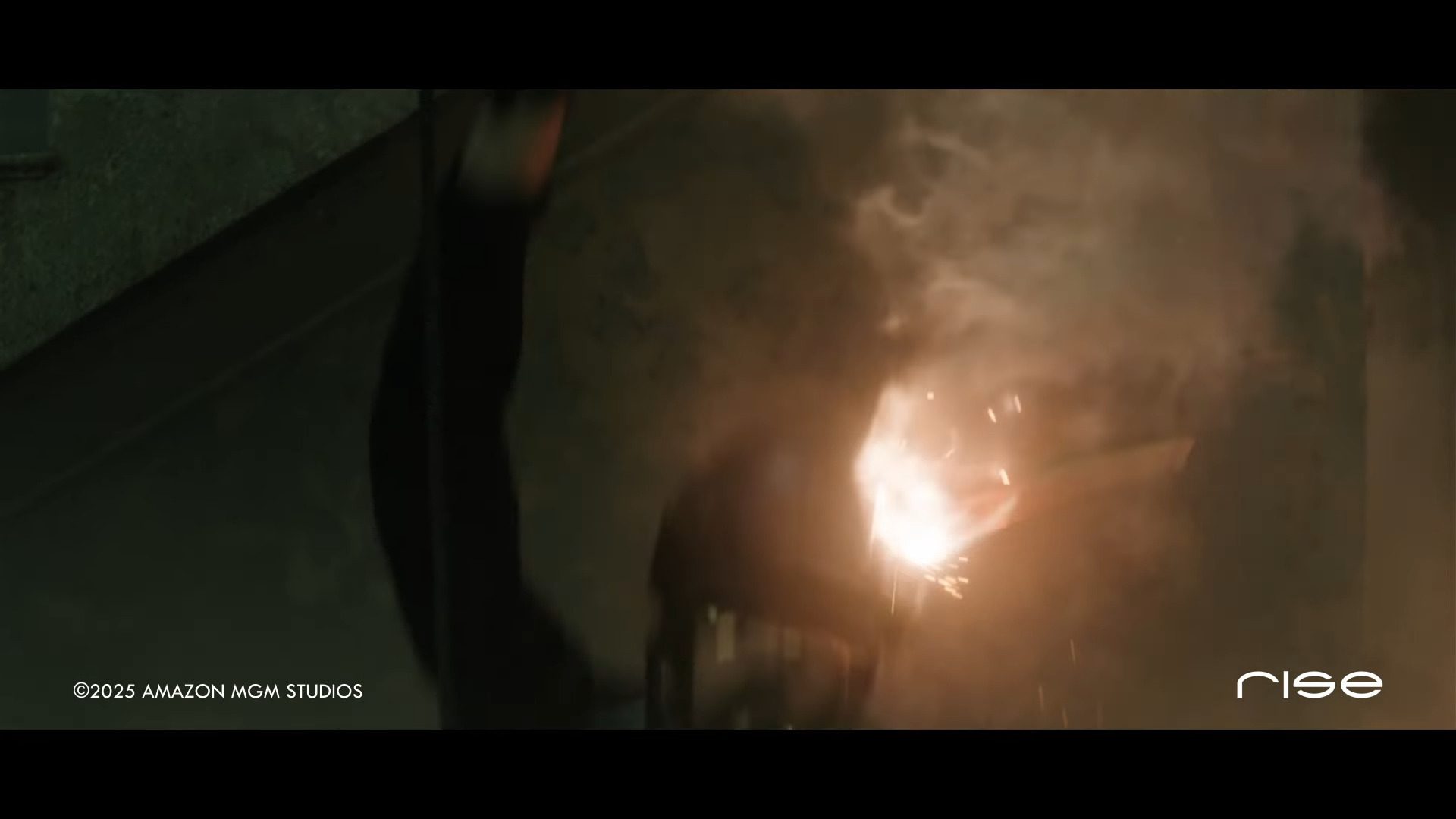 a dynamic action scene featuring a figure in black clothing performing a stunt with sparks flying and an explosion occurring in the background creating an intense atmosphere digital production A dynamic action scene featuring a figure in black clothing performing a stunt, with sparks flying and an explosion occurring in the background, creating an intense atmosphere.