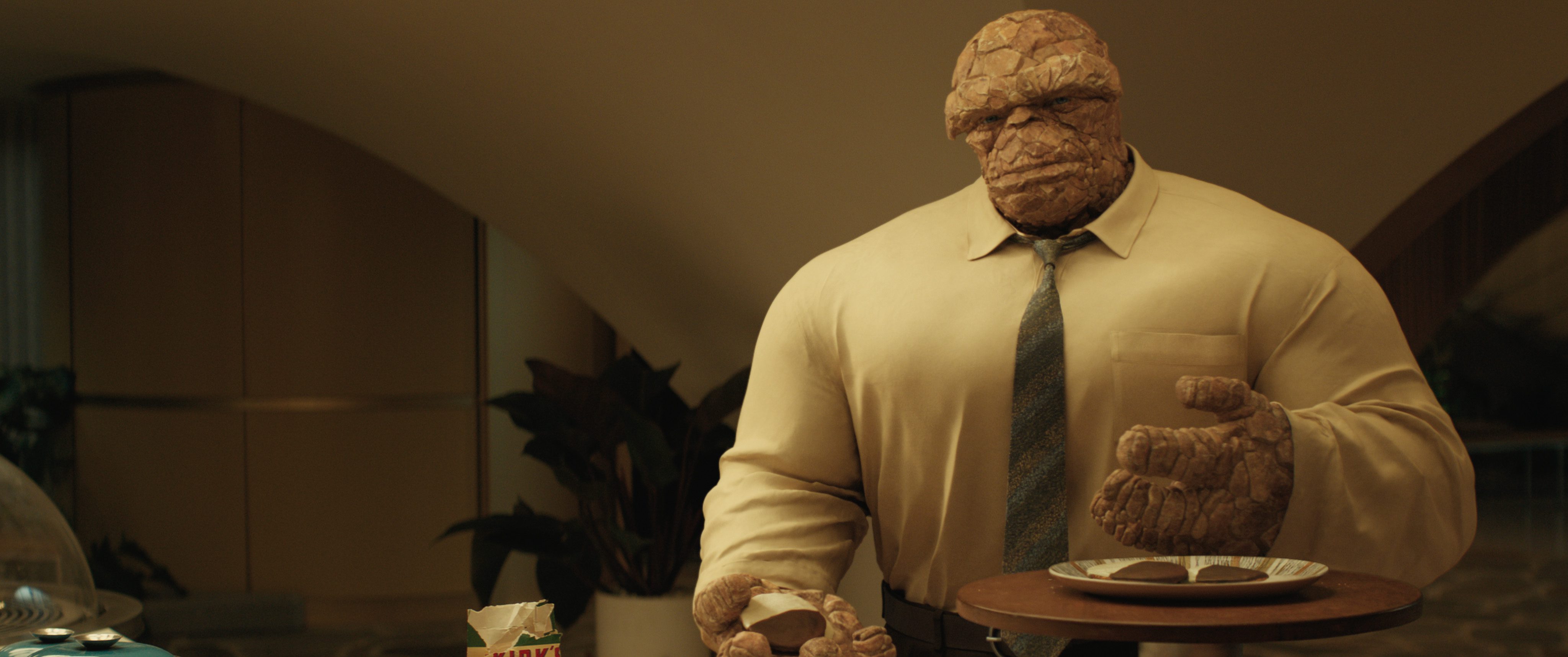 a large rockyskinned character in a buttonup shirt and tie stands in an upscale interior he holds a plate of cookies in one hand appearing relaxed in a modern setting with plants in the background digital production A large, rocky-skinned character in a button-up shirt and tie stands in an upscale interior. He holds a plate of cookies in one hand, appearing relaxed in a modern setting with plants in the background.