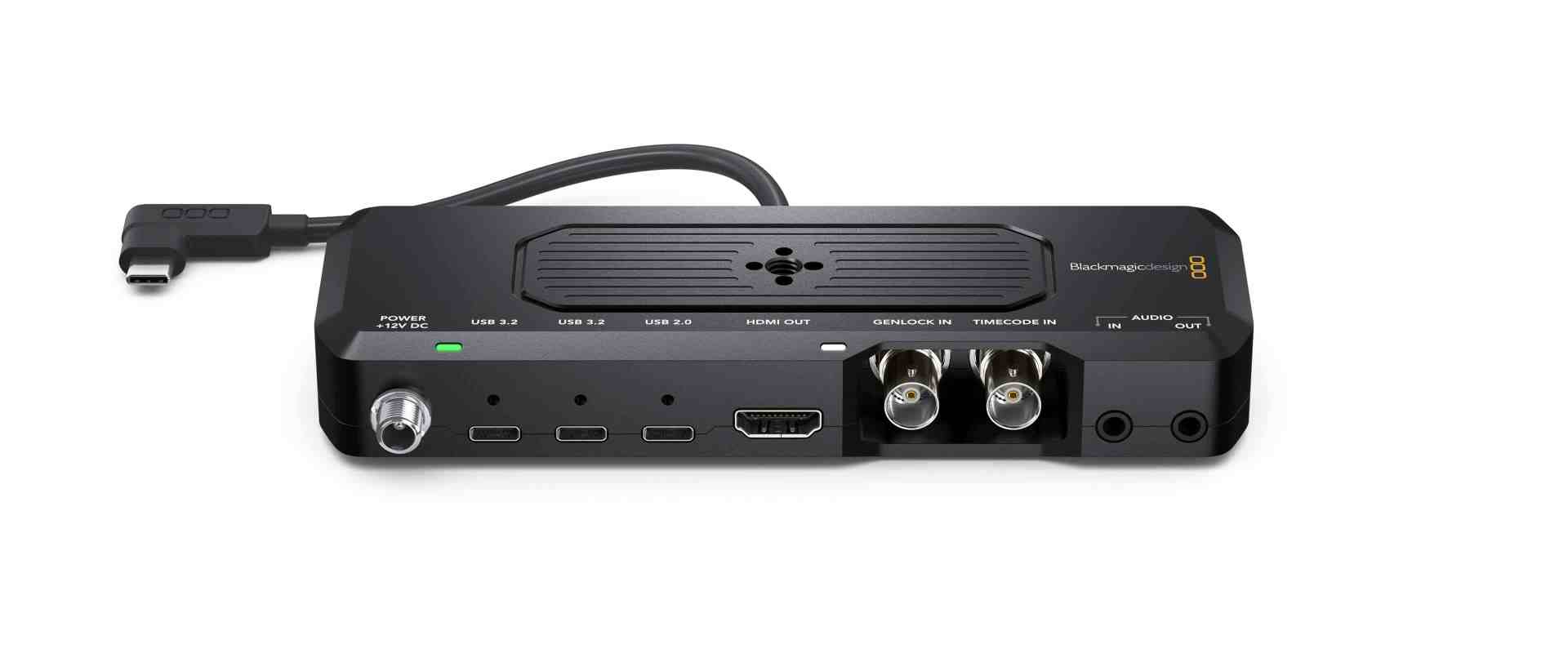 a black video capture device with multiple connection ports including usb hdmi and audio jacks the device features a power button and indicator lights showcasing its sleek and modern design digital production A black video capture device with multiple connection ports, including USB, HDMI, and audio jacks. The device features a power button and indicator lights, showcasing its sleek and modern design.