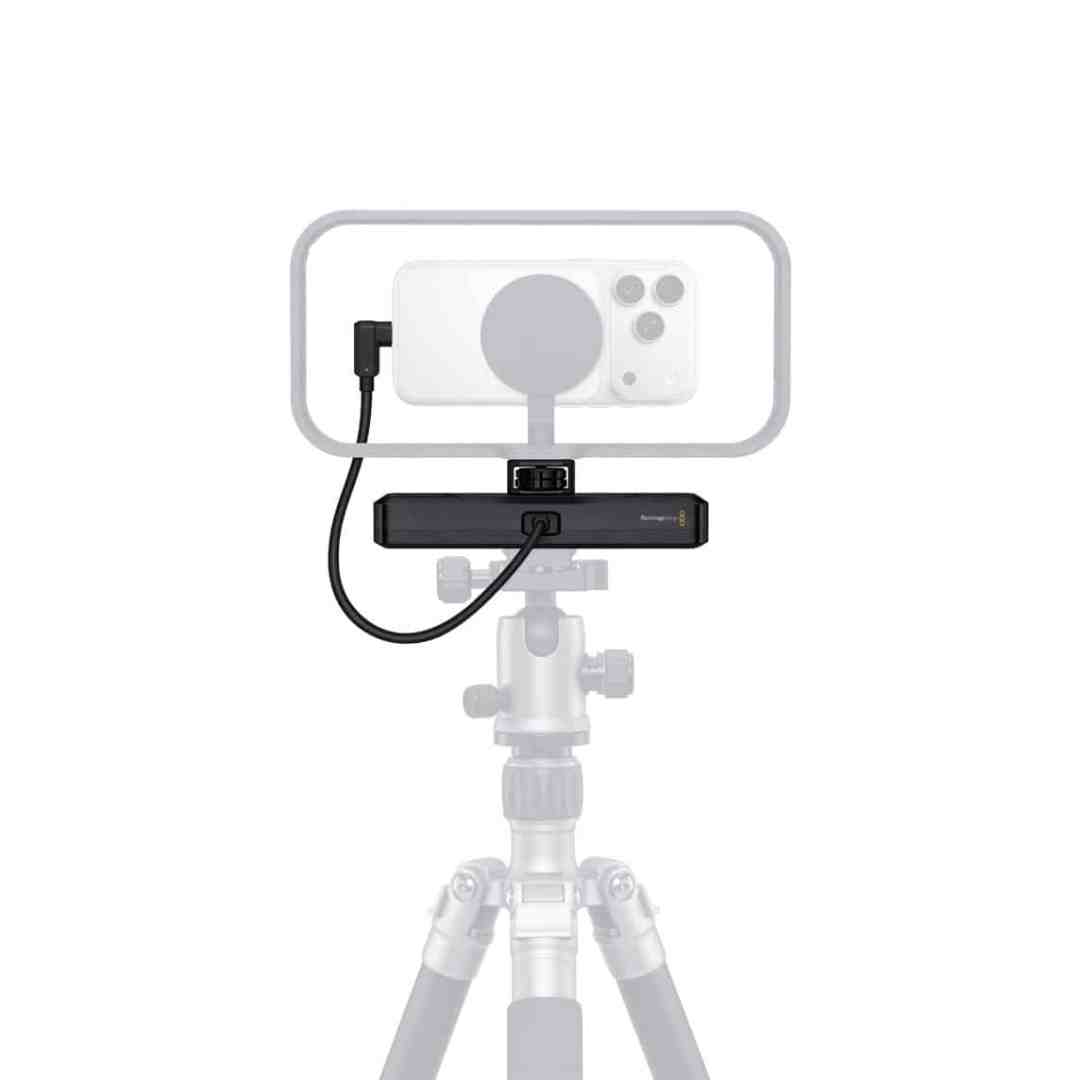 a smartphone mounted on a tripod with an external microphone and audio interface attached the setup is designed for mobile content creation showcasing a streamlined arrangement of equipment digital production A smartphone mounted on a tripod with an external microphone and audio interface attached. The setup is designed for mobile content creation, showcasing a streamlined arrangement of equipment.