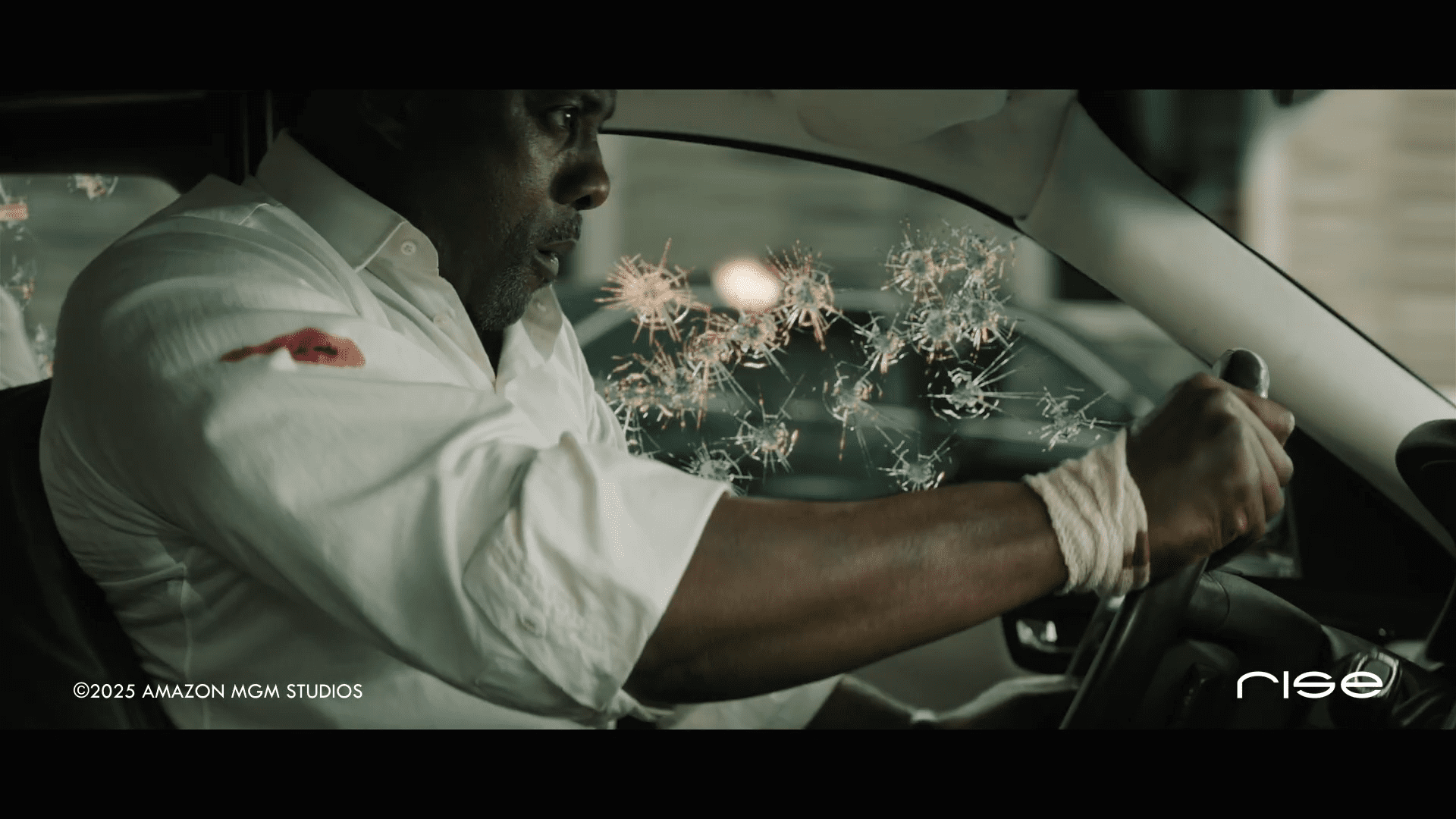 a man gripping the steering wheel of a car showing tension in his face bloodstains are visible on his white shirt the cars windshield has shattered glass particles scattered in the air suggesting a dramatic escape digital production A man gripping the steering wheel of a car, showing tension in his face. Bloodstains are visible on his white shirt. The car's windshield has shattered glass particles scattered in the air, suggesting a dramatic escape.