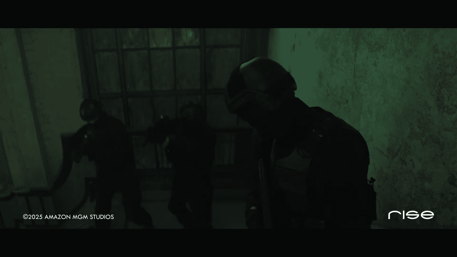 two armed figures in tactical gear are positioned inside a dimly lit abandoned room with a large window casting shadows on the walls the atmosphere is tense and dark suggesting a clandestine operation digital production Two armed figures in tactical gear are positioned inside a dimly lit, abandoned room, with a large window casting shadows on the walls. The atmosphere is tense and dark, suggesting a clandestine operation.