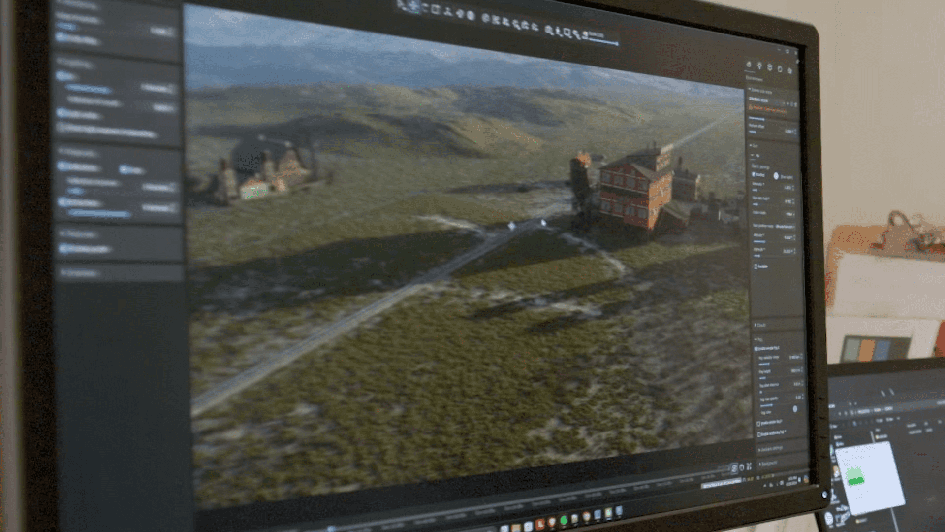 a computer monitor displaying a highresolution rendering of a landscape featuring a winding road leading to a large red building surrounded by greenery and hills in the background digital production A computer monitor displaying a high-resolution rendering of a landscape, featuring a winding road leading to a large red building surrounded by greenery and hills in the background.