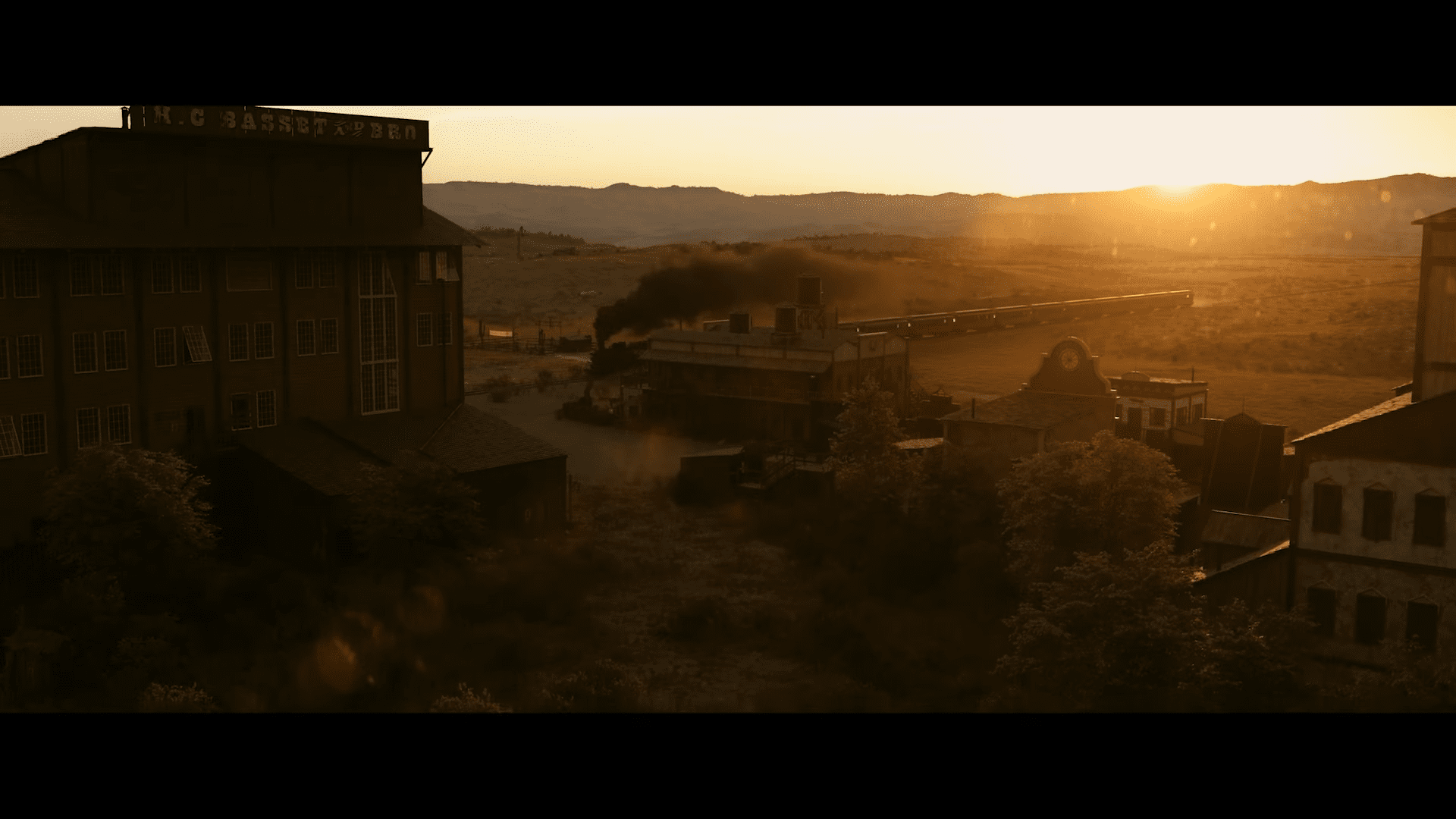 a panoramic view of an abandoned industrial site at sunset featuring a large building with a sign a smoky train in the background and distant mountains the scene is illuminated by golden hues as the day ends digital production A panoramic view of an abandoned industrial site at sunset, featuring a large building with a sign, a smoky train in the background, and distant mountains. The scene is illuminated by golden hues as the day ends.
