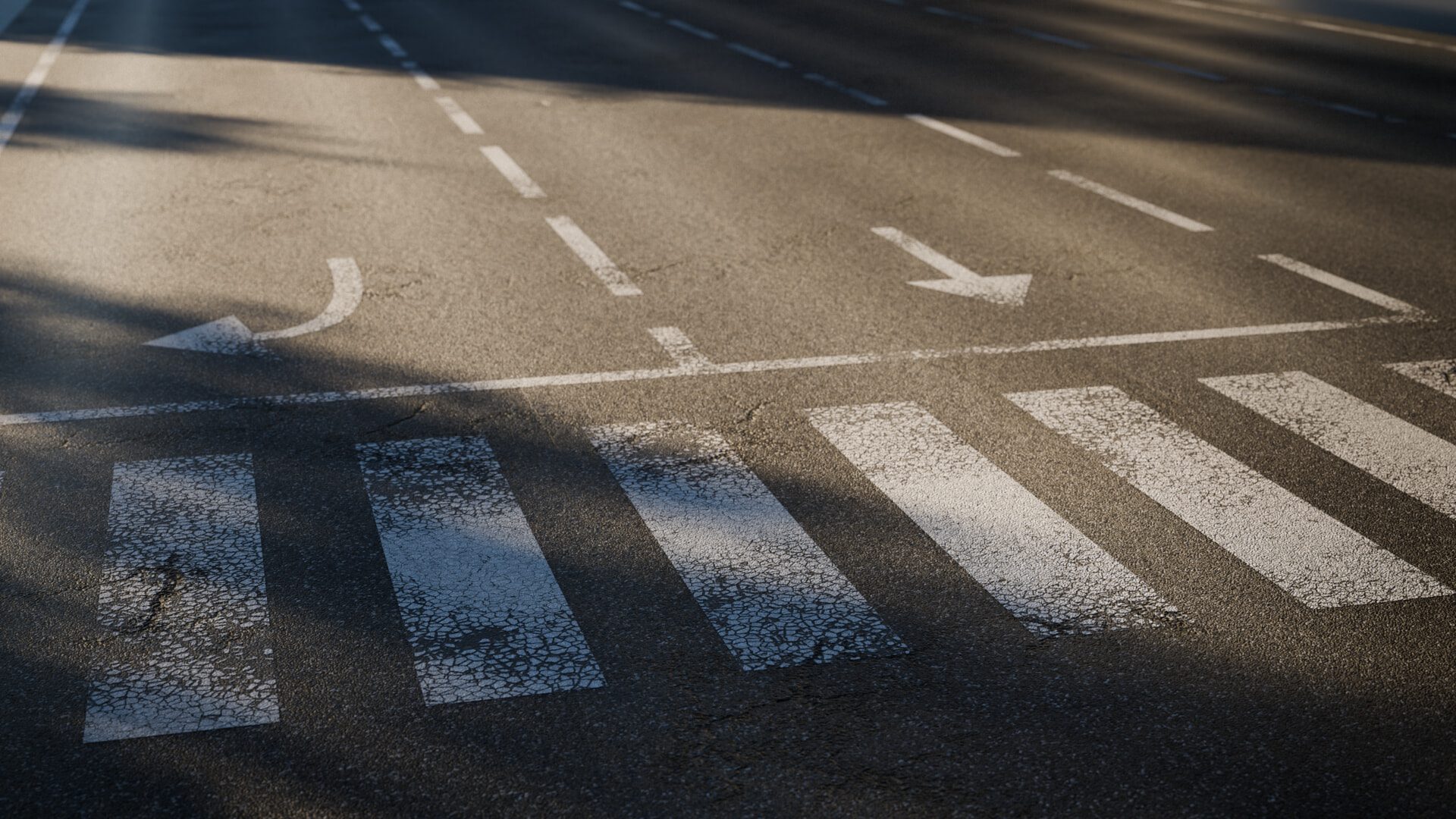 a closeup view of a paved road featuring faded white lane markings including a left turn lane and a crosswalk soft shadows are cast across the road indicating a sunny day digital production https://public-files.gumroad.com/elp5euu2fzdtllkwzpatjt8e982u