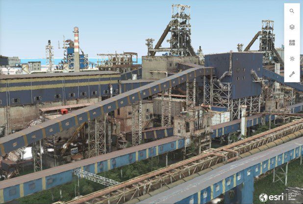 aerial view of an industrial facility featuring multiple buildings conveyor belts and machinery the landscape includes greenery surrounding the facility with a blue sky in the background digital production Aerial view of an industrial facility featuring multiple buildings, conveyor belts, and machinery. The landscape includes greenery surrounding the facility, with a blue sky in the background.