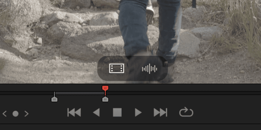 a closeup view of a video playback interface featuring a person walking on a rocky path the playback controls appear at the bottom including buttons for play pause and navigation digital production A close-up view of a video playback interface, featuring a person walking on a rocky path. The playback controls appear at the bottom, including buttons for play, pause, and navigation.