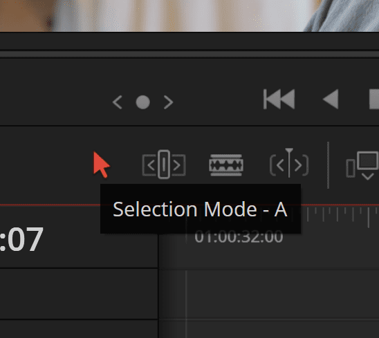 a closeup of a video editing software interface highlighting the selection mode a button with a red arrow cursor above it the timeline displays time codes and editing controls in a dark layout digital production A close-up of a video editing software interface, highlighting the 'Selection Mode - A' button with a red arrow cursor above it. The timeline displays time codes and editing controls in a dark layout.