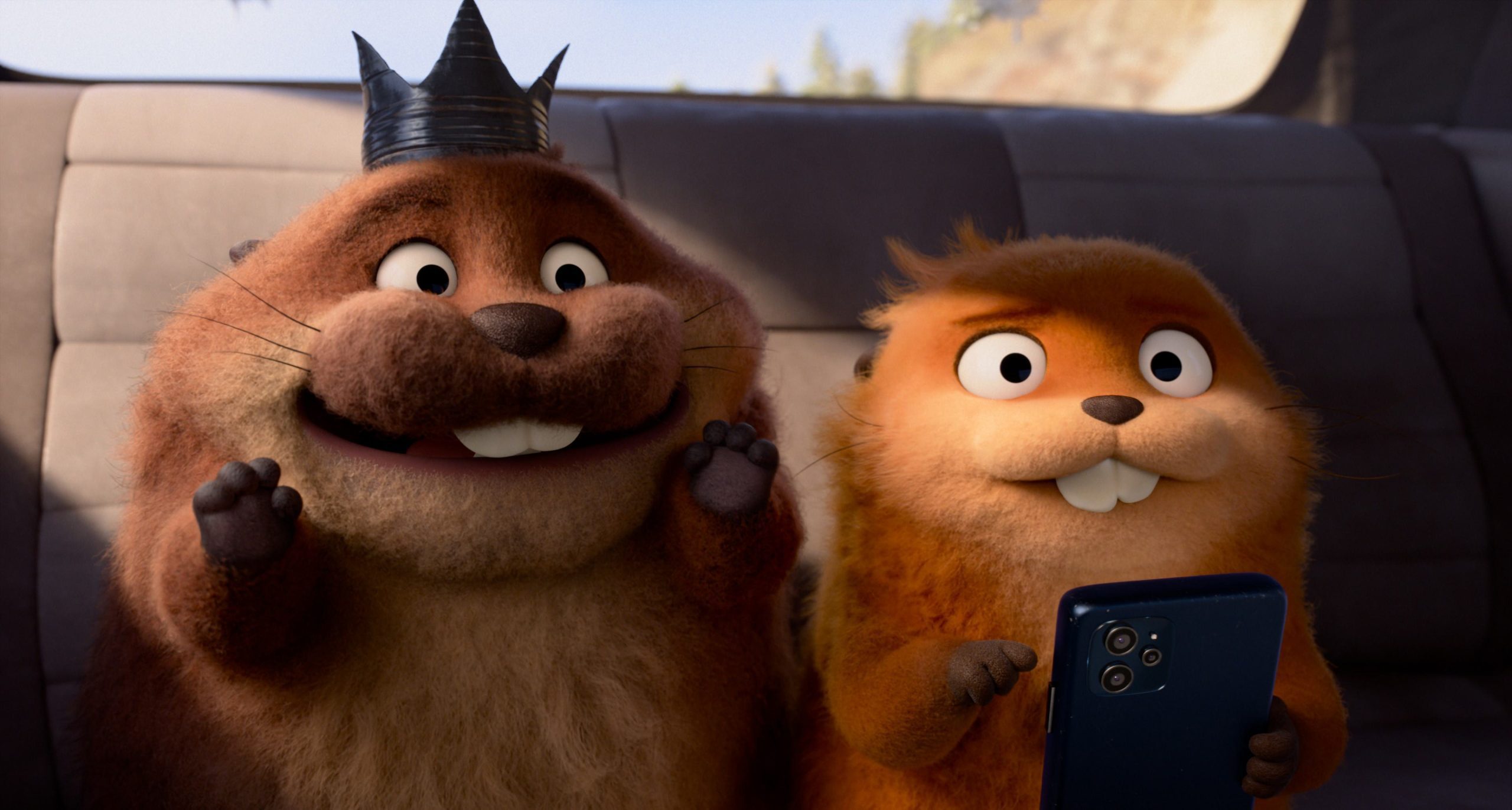 two animated beavers sitting on a car seat one beaver wears a black crown and smiles while the other beaver holds a smartphone and grins widely the background features a sunny outdoor scene digital production Two animated beavers sitting on a car seat. One beaver wears a black crown and smiles, while the other beaver holds a smartphone and grins widely. The background features a sunny outdoor scene.