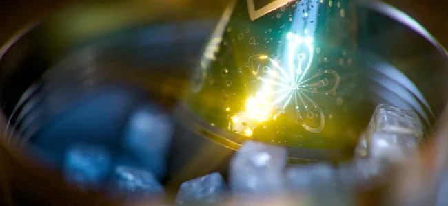 a closeup of a sparkling beverage bottle partially submerged in clear ice cubes with bright reflections and colors creating an appealing visual in a circular metallic container digital production https://helpx-prod.scene7.com/is/image/HelpxProd/v12_banner_post_effects2?$pjpeg$&jpegSize=200&wid=650