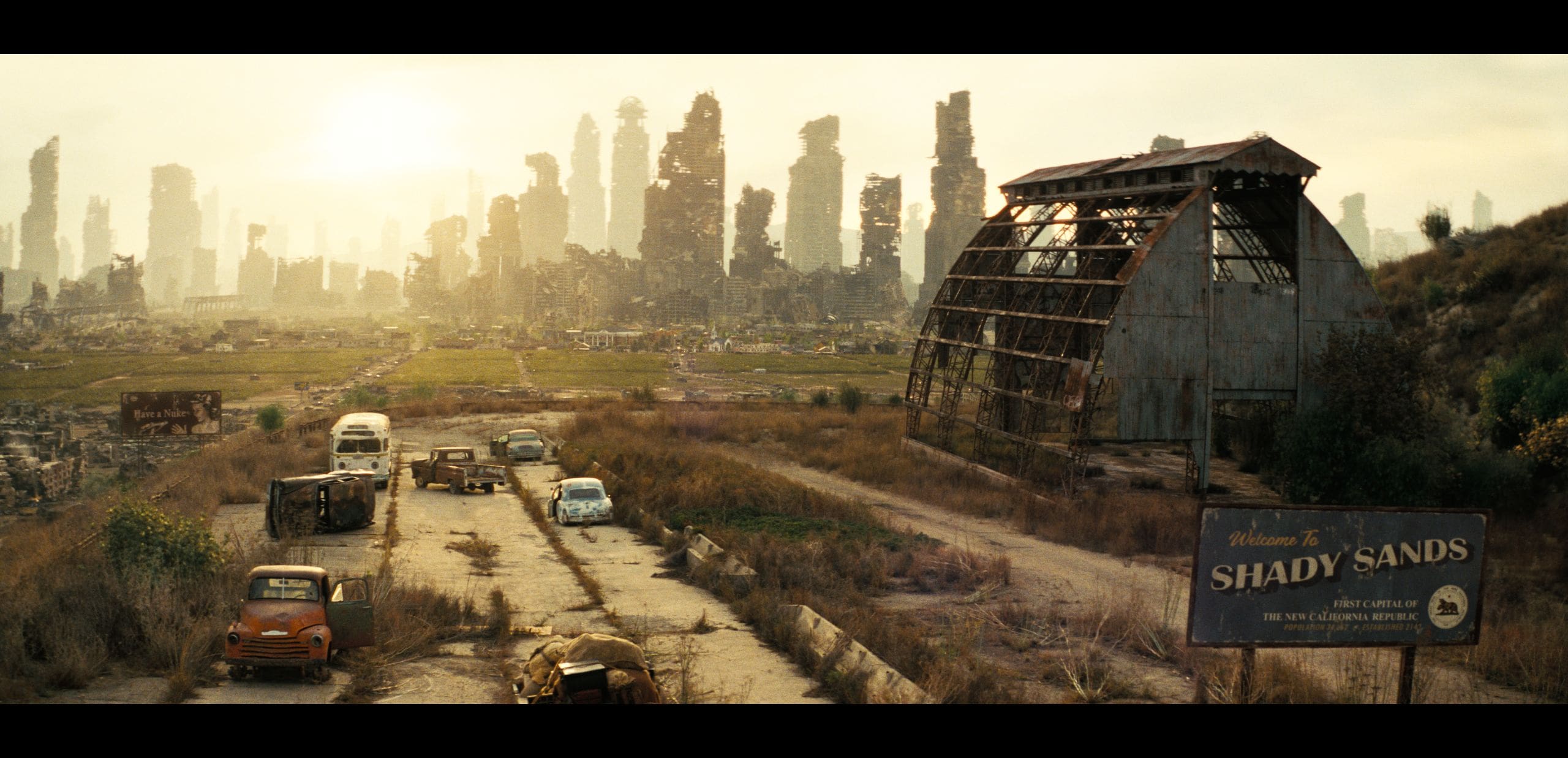 a desolate landscape filled with crumbling skyscrapers under a hazy sky abandoned cars rust on a cracked road leading to a dilapidated barn a weathered sign for shady sands stands amidst overgrown grass evoking a oncevibrant community now lost to time digital production A desolate landscape filled with crumbling skyscrapers under a hazy sky. Abandoned cars rust on a cracked road leading to a dilapidated barn. A weathered sign for "Shady Sands" stands amidst overgrown grass, evoking a once-vibrant community now lost to time.