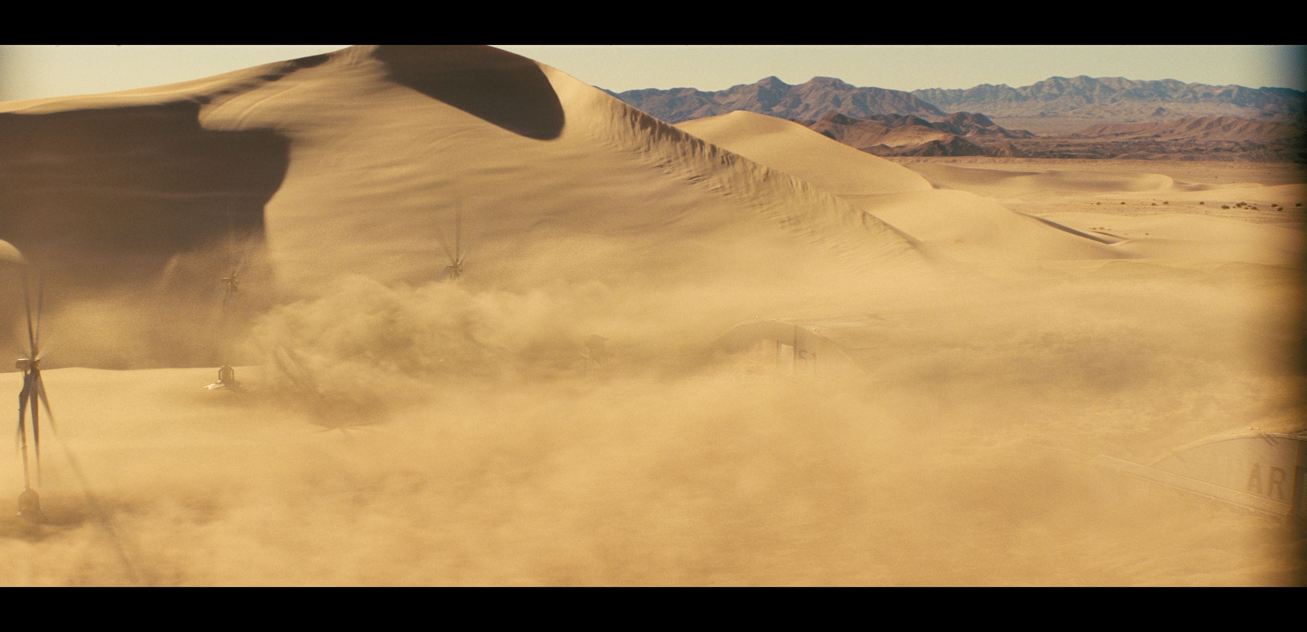 a sweeping view of an expansive desert with towering golden sand dunes the dunes ripple gracefully against a backdrop of distant mountains while soft clouds of sand swirl in the warm breeze creating an ethereal sunkissed landscape the sky is clear highlighting the vast arid beauty digital production A sweeping view of an expansive desert with towering, golden sand dunes. The dunes ripple gracefully against a backdrop of distant mountains, while soft clouds of sand swirl in the warm breeze, creating an ethereal, sun-kissed landscape. The sky is clear, highlighting the vast, arid beauty.