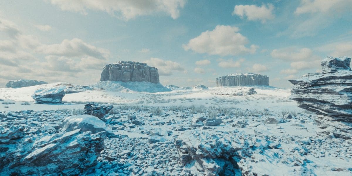 a panoramic view of a vast snowcovered landscape two large rock formations rise majestically against a backdrop of soft fluffy clouds the ground is scattered with rugged boulders and a blanket of powdery snow covers the scene reflecting a serene icy blue hue under a clear sky digital production A panoramic view of a vast, snow-covered landscape. Two large rock formations rise majestically against a backdrop of soft, fluffy clouds. The ground is scattered with rugged boulders, and a blanket of powdery snow covers the scene, reflecting a serene, icy blue hue under a clear sky.
