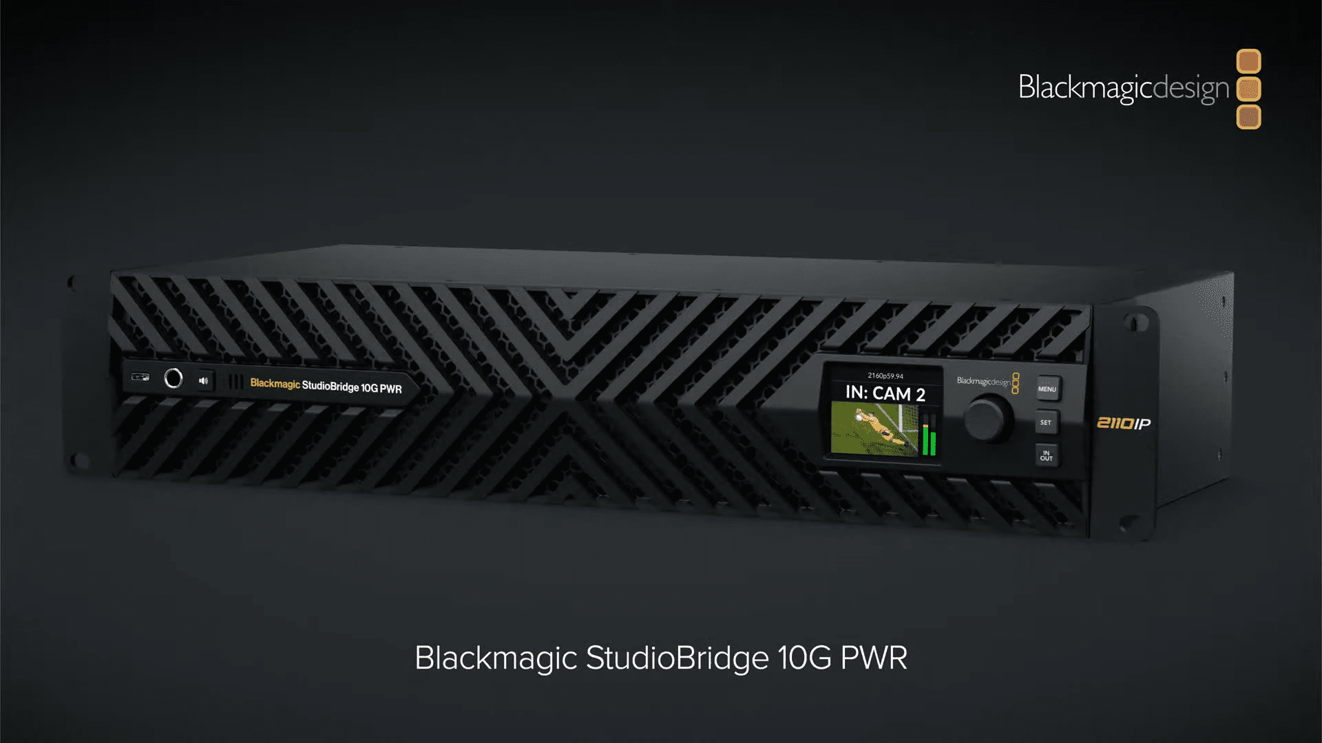 a sleek blackmagic studiobridge 10g pwr device with a textured black front panel featuring a geometric design a small display shows the input signal from in cam 2 with audio levels while control knobs and buttons add to its professional hightech appearance digital production A sleek Blackmagic StudioBridge 10G PWR device with a textured black front panel featuring a geometric design. A small display shows the input signal from "IN: CAM 2" with audio levels, while control knobs and buttons add to its professional, high-tech appearance.