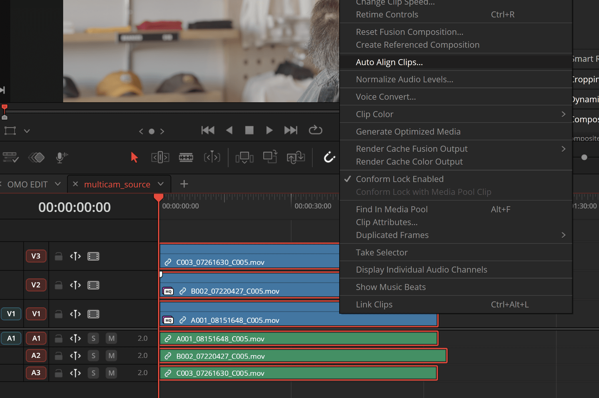 a closeup view of a video editing timeline in davinci resolve colorcoded clips marked in blue and red are displayed on multiple tracks the interface shows playback controls and menu options with a blurred backdrop of editing equipment and storage items digital production A close-up view of a video editing timeline in DaVinci Resolve. Color-coded clips, marked in blue and red, are displayed on multiple tracks. The interface shows playback controls and menu options, with a blurred backdrop of editing equipment and storage items.