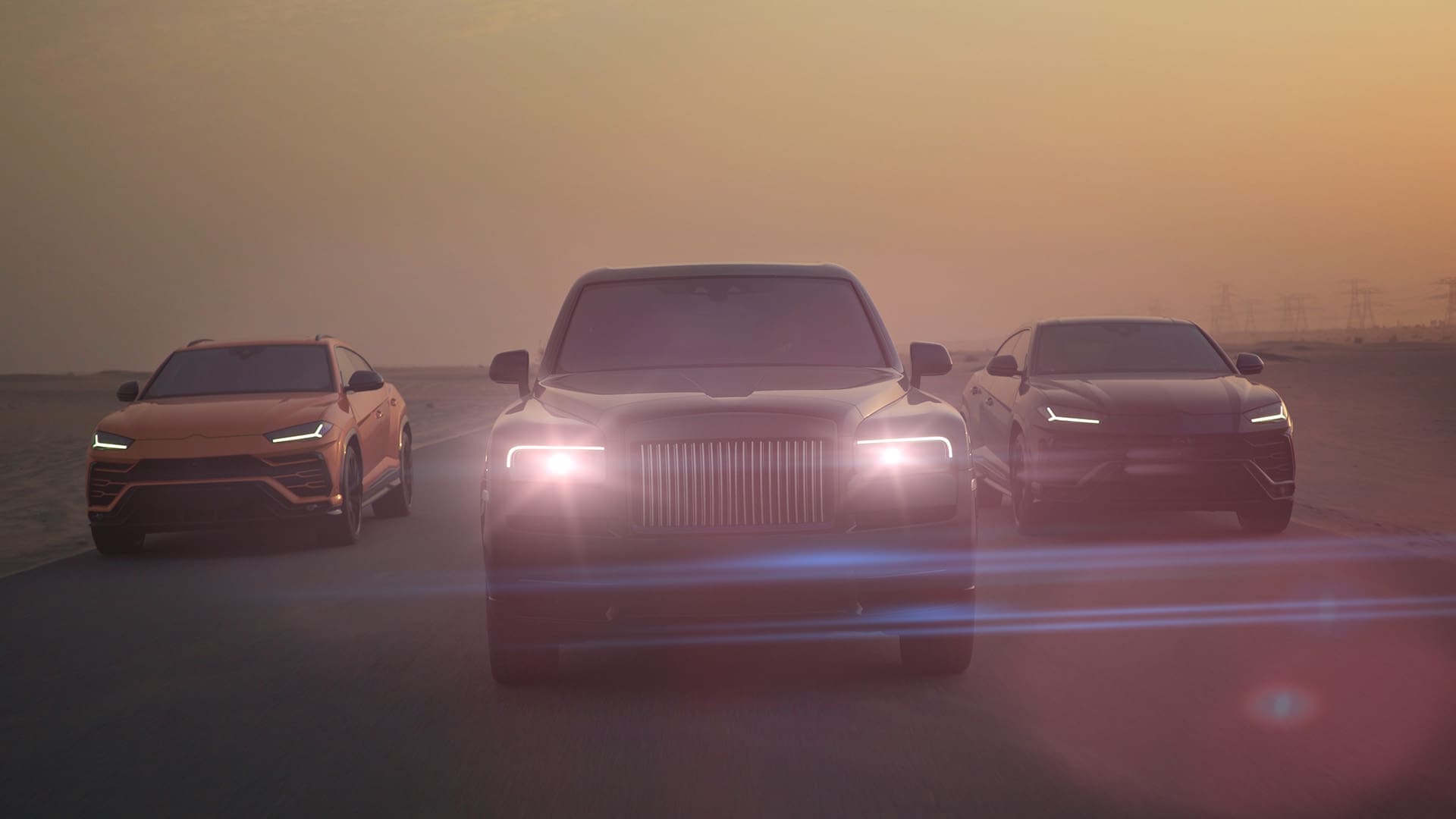 three luxury vehicles stand poised on an empty road at sunset the central model glistening in deep black exudes elegance with its bold grill and illuminated headlights flanking it a sleek gray suv and a radiant orange crossover add depth to the striking lineup bathed in soft golden light digital production Three luxury vehicles stand poised on an empty road at sunset. The central model, glistening in deep black, exudes elegance with its bold grill and illuminated headlights. Flanking it, a sleek gray SUV and a radiant orange crossover add depth to the striking lineup, bathed in soft, golden light.