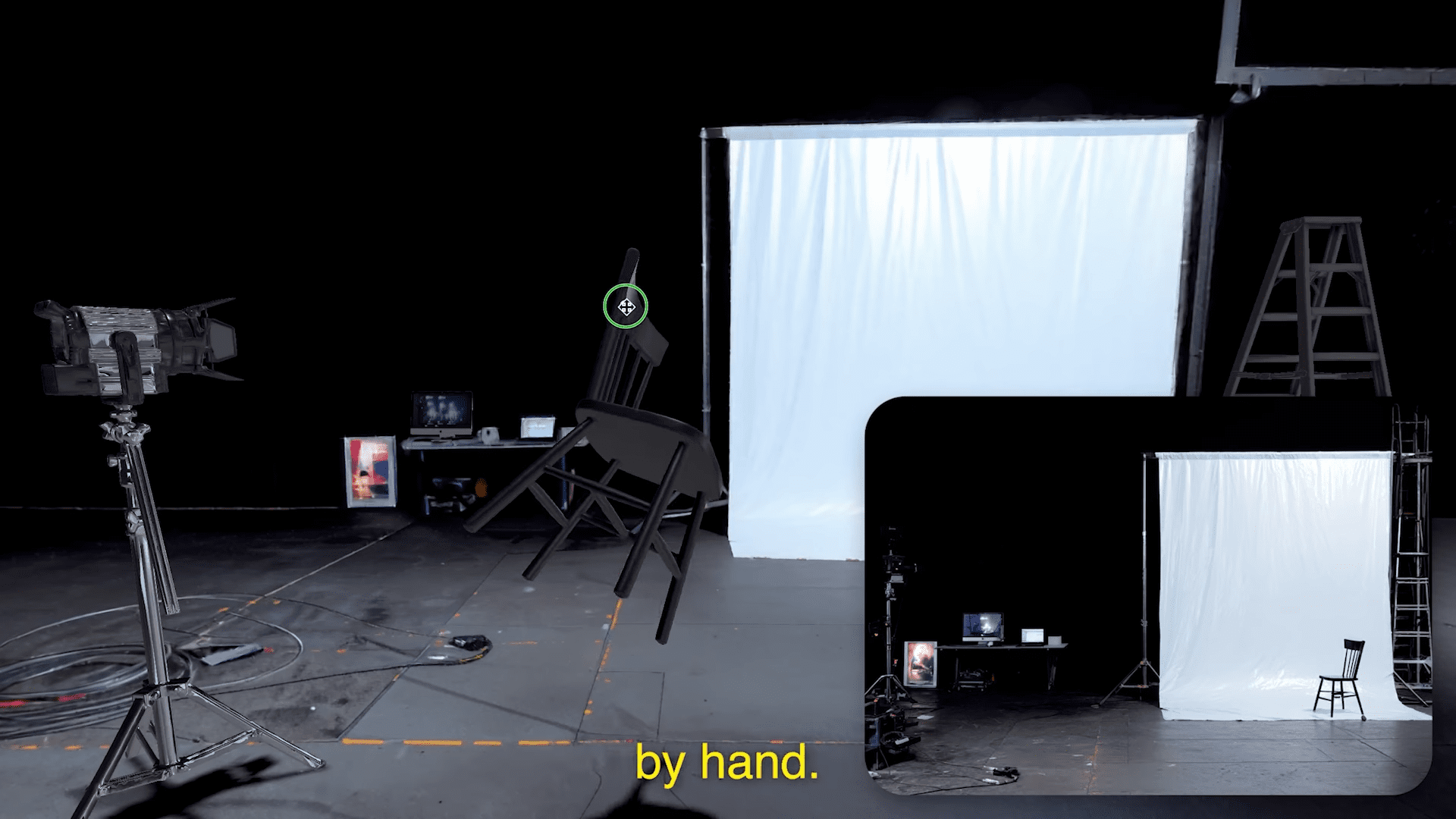 a dimly lit studio space showcases a plain white backdrop draped smoothly contrasting with the surrounding shadows in the foreground a black chair stands at an angle while a tripod with an overhead light illuminates the area a small table holds equipment enhancing the scenes production quality digital production A dimly lit studio space showcases a plain white backdrop draped smoothly, contrasting with the surrounding shadows. In the foreground, a black chair stands at an angle, while a tripod with an overhead light illuminates the area. A small table holds equipment, enhancing the scene's production quality.